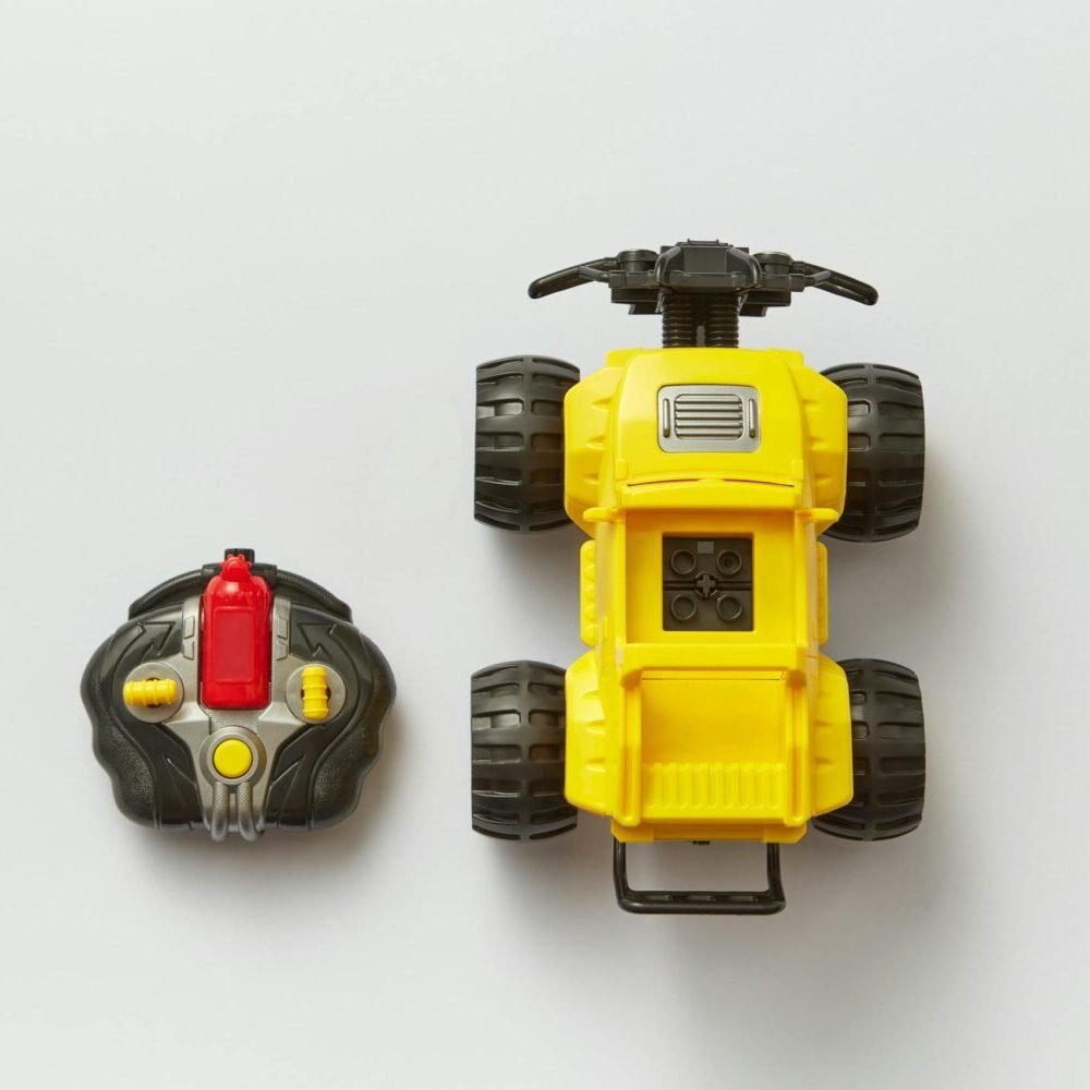Overhead view of a yellow remote-controlled toy car with its controller on a white background.